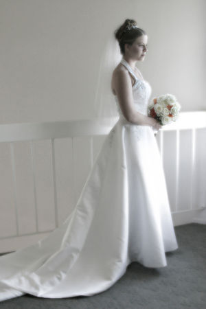 A bride in a very traditional long white weddi...